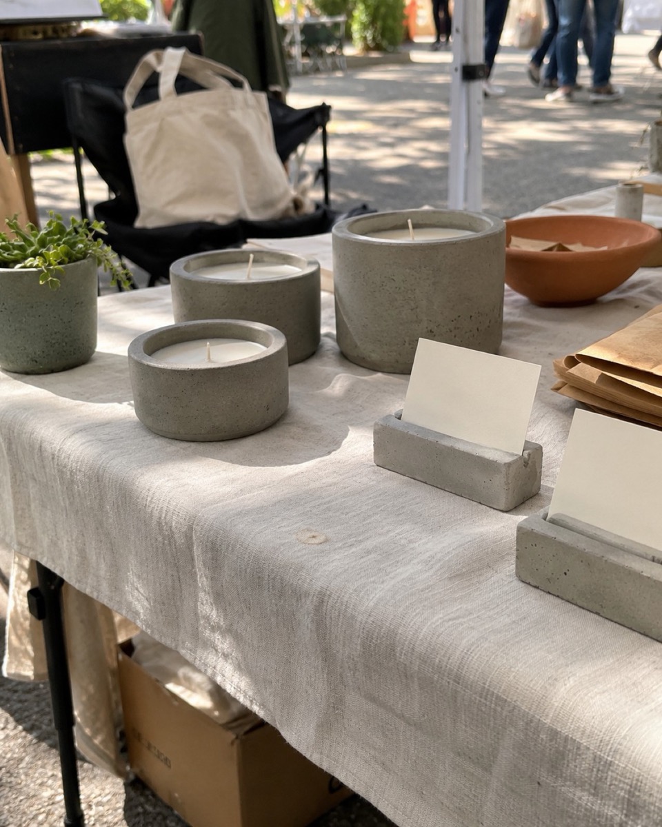 A small craft market table with concrete planters and coasters on display